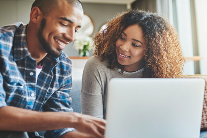 A man and woman applying on a lap top